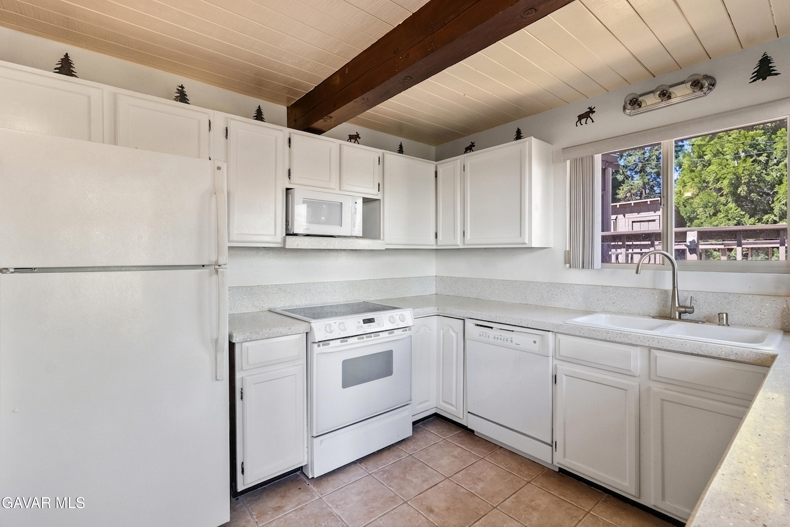 25631 High Rock Court Tehachapi, CA 93561 - Photo 10 of 31 a kitchen with white cabinets and white appliances