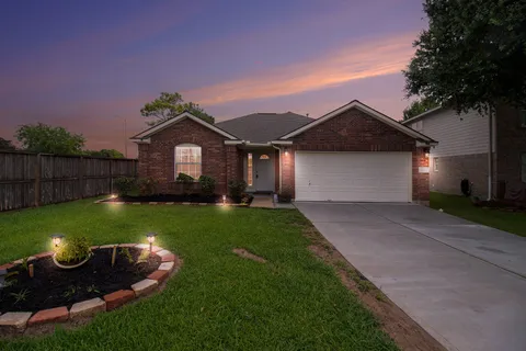 a front view of a house with a yard fire pit and outdoor seating