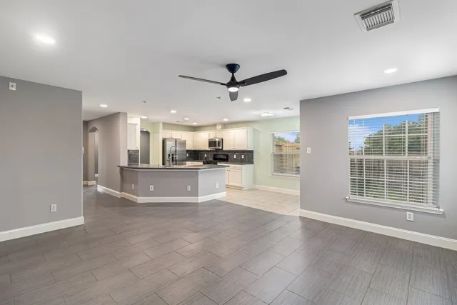 a view of a kitchen with a sink and a window