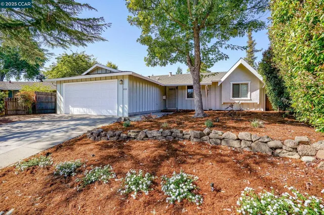 a backyard of a house with large trees