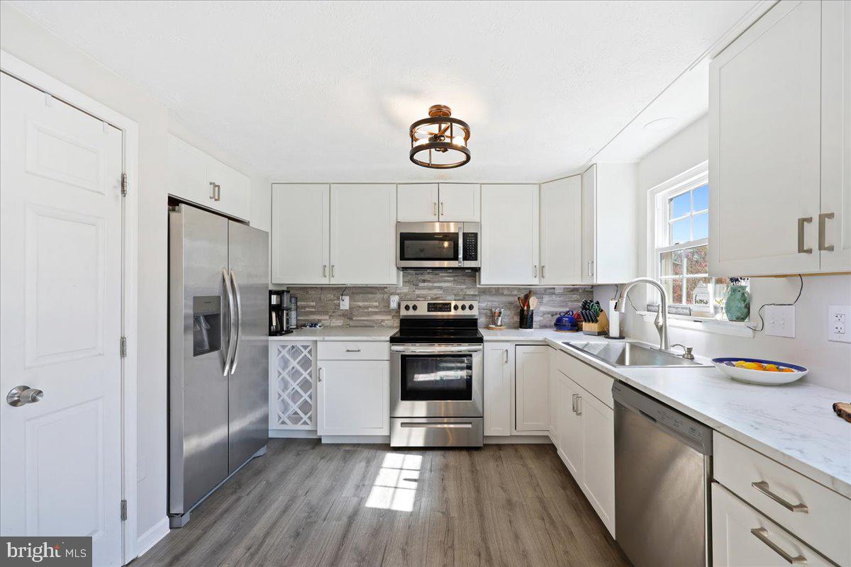 1476 Dockside Court Frederick, MD 21701 - Photo 11 of 34 a kitchen with a sink cabinets stainless steel appliances and a window