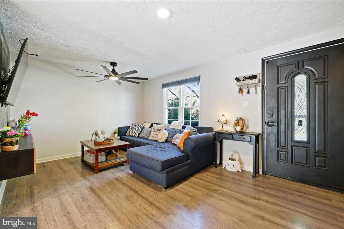 1476 Dockside Court Frederick, MD 21701 - Photo 7 of 34 a living room with furniture and a wooden floor