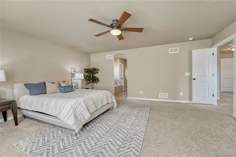 a bedroom with a large bed and a window
