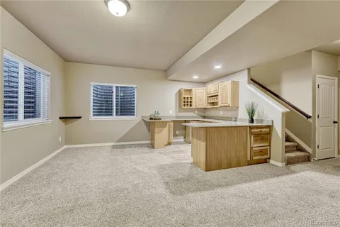 an empty room with a cabinet and mirrors