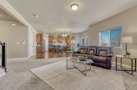 a kitchen with a table chairs sink and cabinets