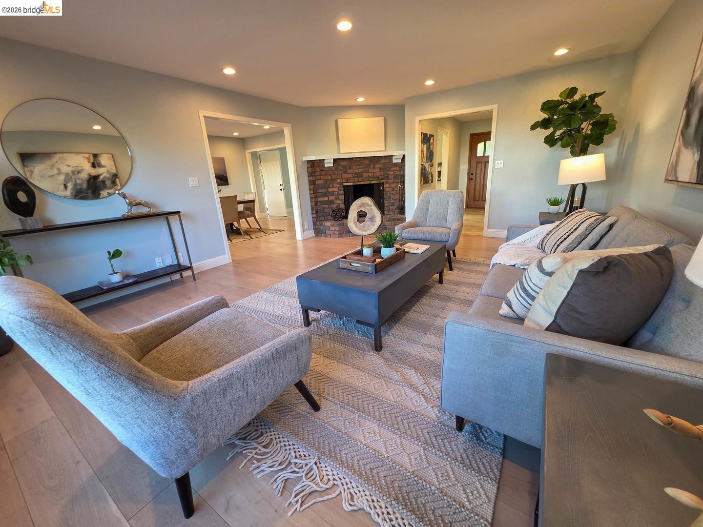 965 Springer Road Los Altos, CA 94024 - Photo 6 of 31 Living room featuring light wood-finish flooring, recessed lighting, a brick fireplace, and light-toned wall paint