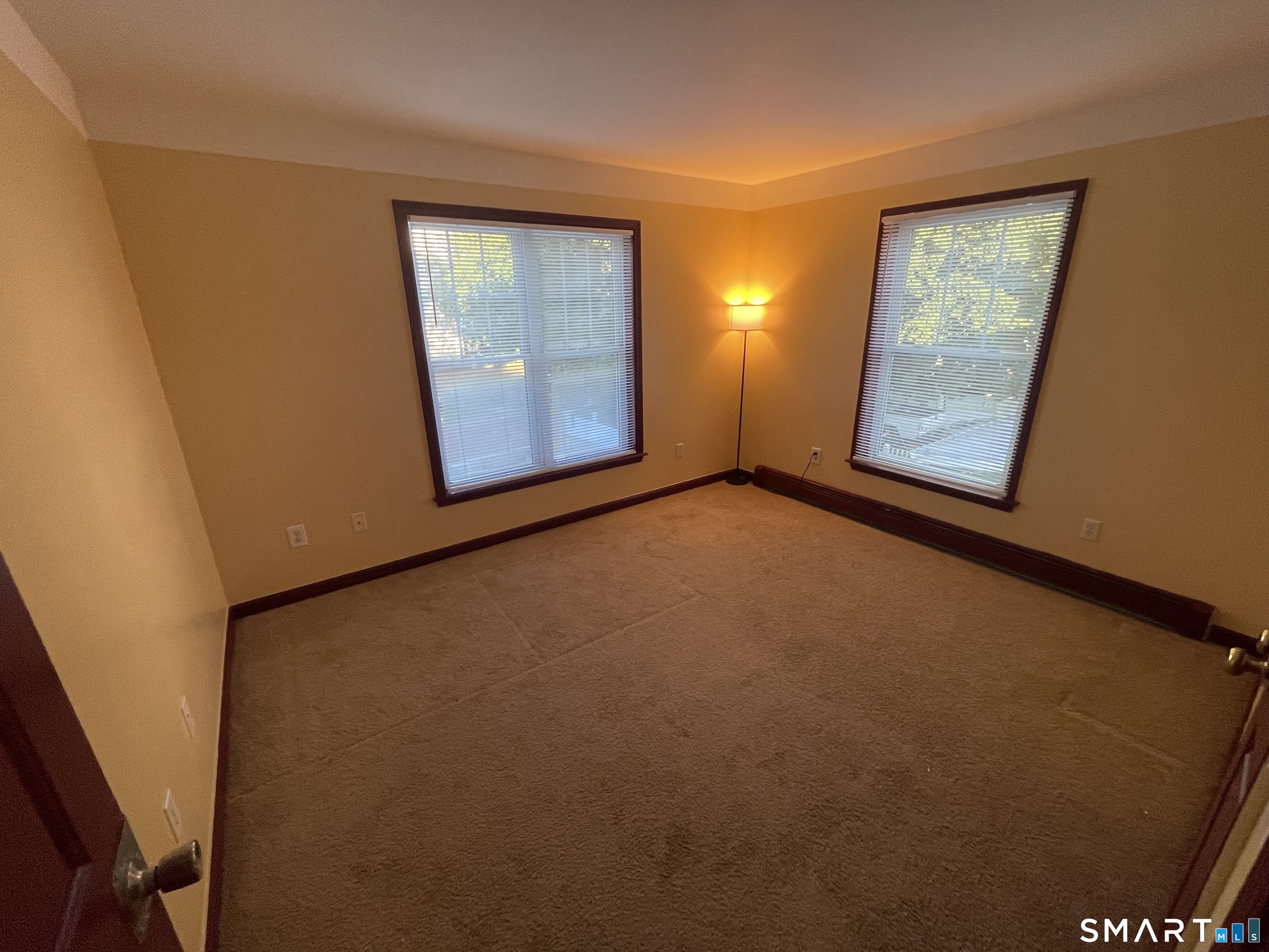 11 Button Street New Haven, CT 06519 - Photo 11 of 18 a view of an empty room with window and wooden floor