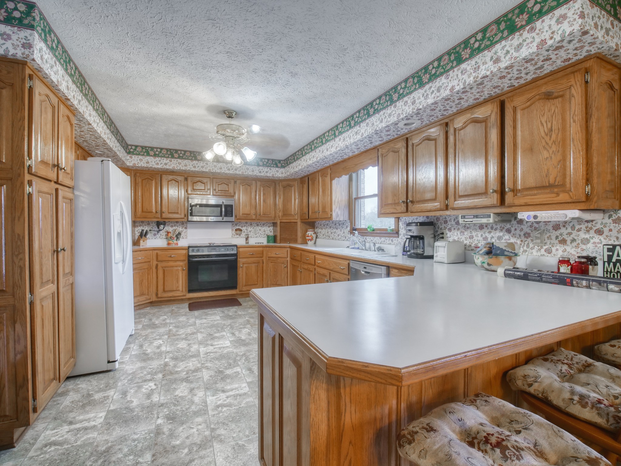 5149 Beech Log Road Lebanon, TN 37090 - Photo 20 of 44 a large kitchen with kitchen island granite countertop wooden cabinets a sink and a stove