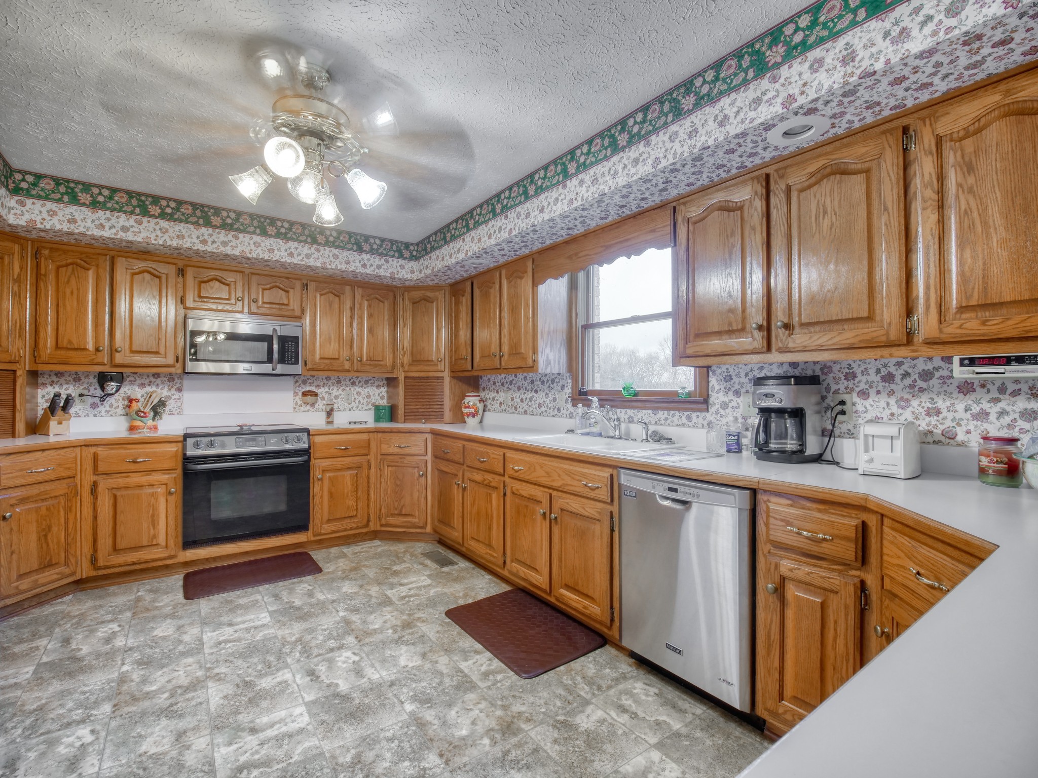 5149 Beech Log Road Lebanon, TN 37090 - Photo 24 of 44 a kitchen with stainless steel appliances granite countertop a stove sink cabinets and window