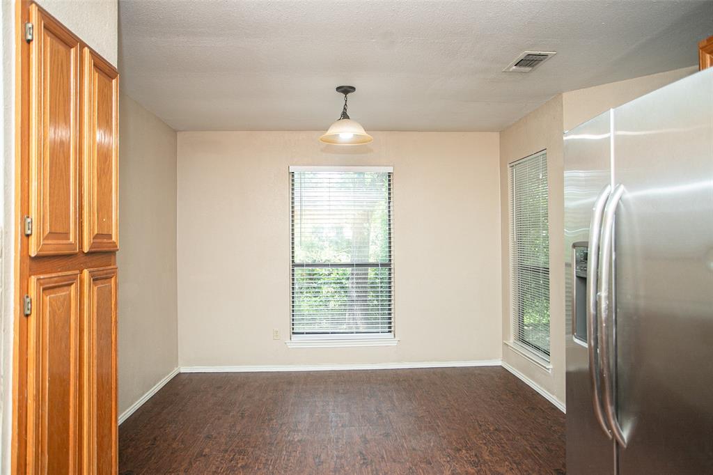 2019 West Nathan Lowe Road Arlington, TX 76017 - Photo 7 of 21 wood-finish flooring, neutral wall tones, and a single window with horizontal blinds