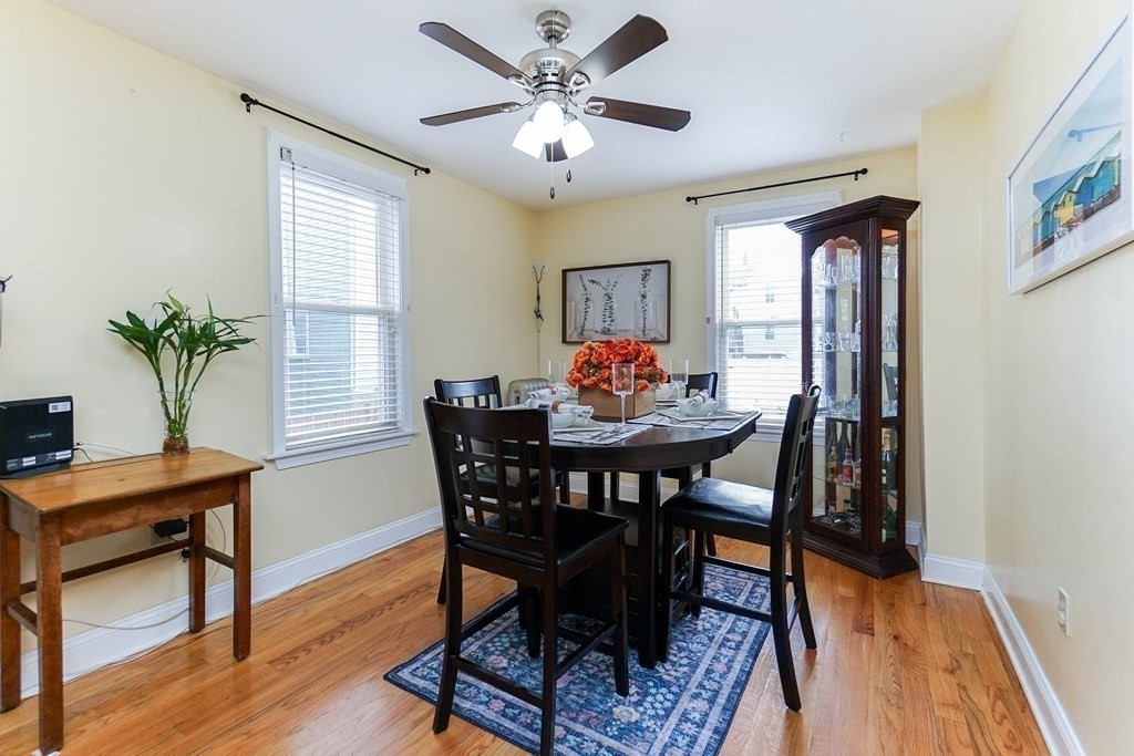 291 Carter Street Chelsea, MA 02150 - Photo 12 of 40 a dining room with furniture potted plants and wooden floor