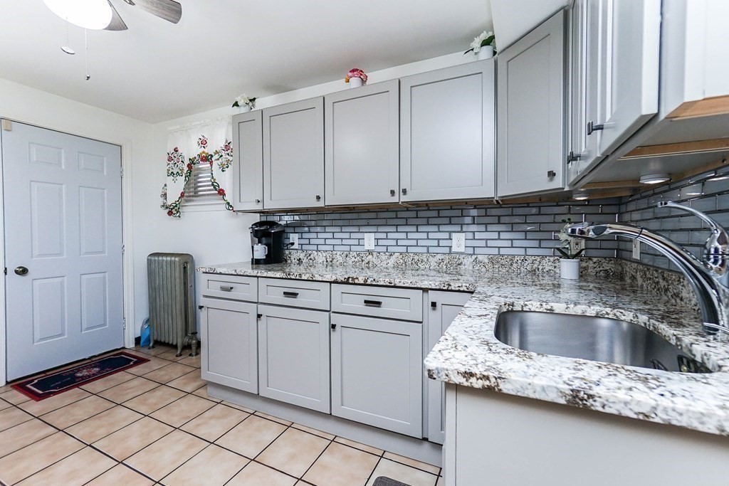 291 Carter Street Chelsea, MA 02150 - Photo 18 of 40 a kitchen with white cabinets a sink and dishwasher