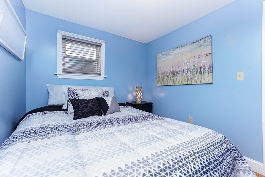 291 Carter Street Chelsea, MA 02150 - Photo 25 of 40 a bedroom with a bed and painting on the wall