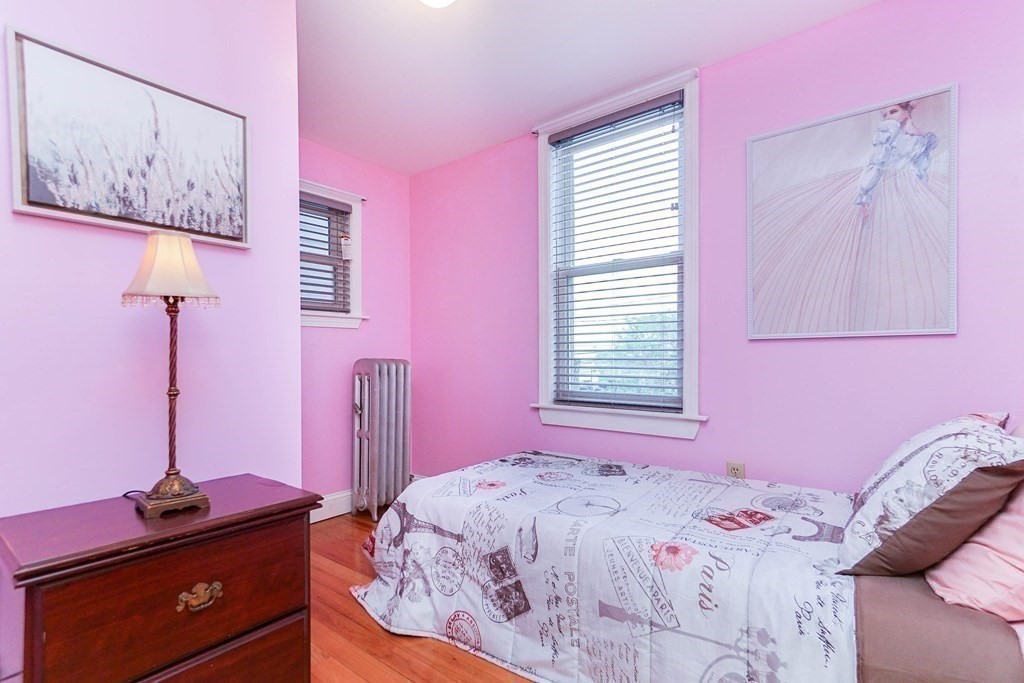 291 Carter Street Chelsea, MA 02150 - Photo 26 of 40 a bedroom with a bed and a dresser