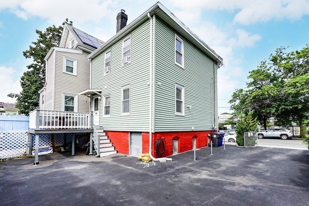 291 Carter Street Chelsea, MA 02150 - Photo 5 of 40 a view of a house with a patio and a yard