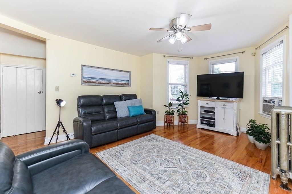 291 Carter Street Chelsea, MA 02150 - Photo 9 of 40 a living room with furniture and a flat screen tv
