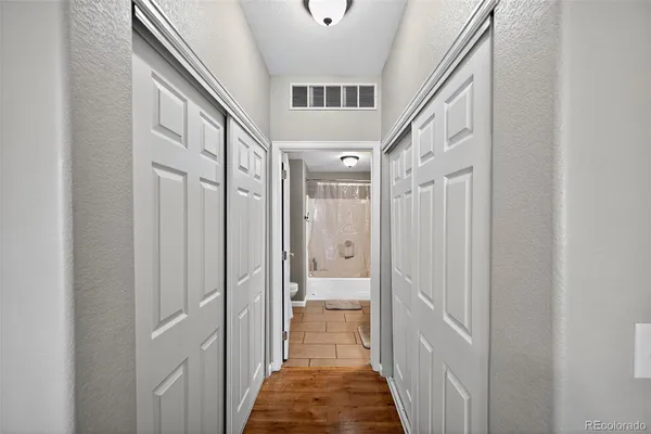 a bathroom with a double vanity sink and mirror with bathtub