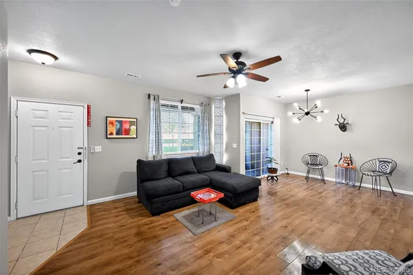 a living room with furniture and wooden floor