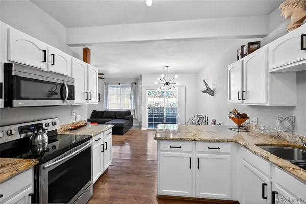 a kitchen with cabinets a sink and appliances