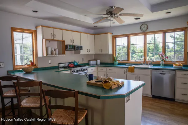 a kitchen with a table chairs stove and cabinets