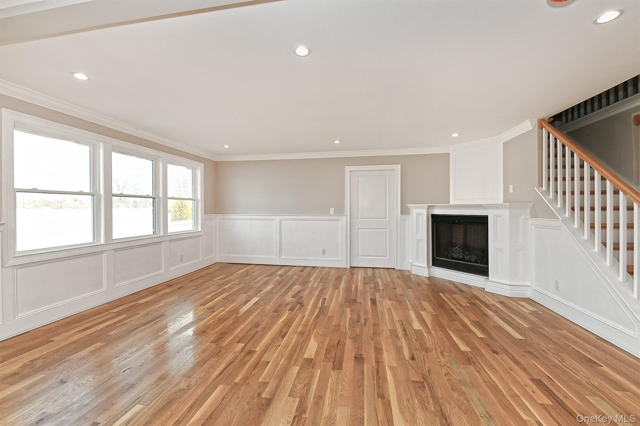 1903 George Court Merrick, NY 11566 - Photo 15 of 39 a view of empty room with wooden floor and fireplace