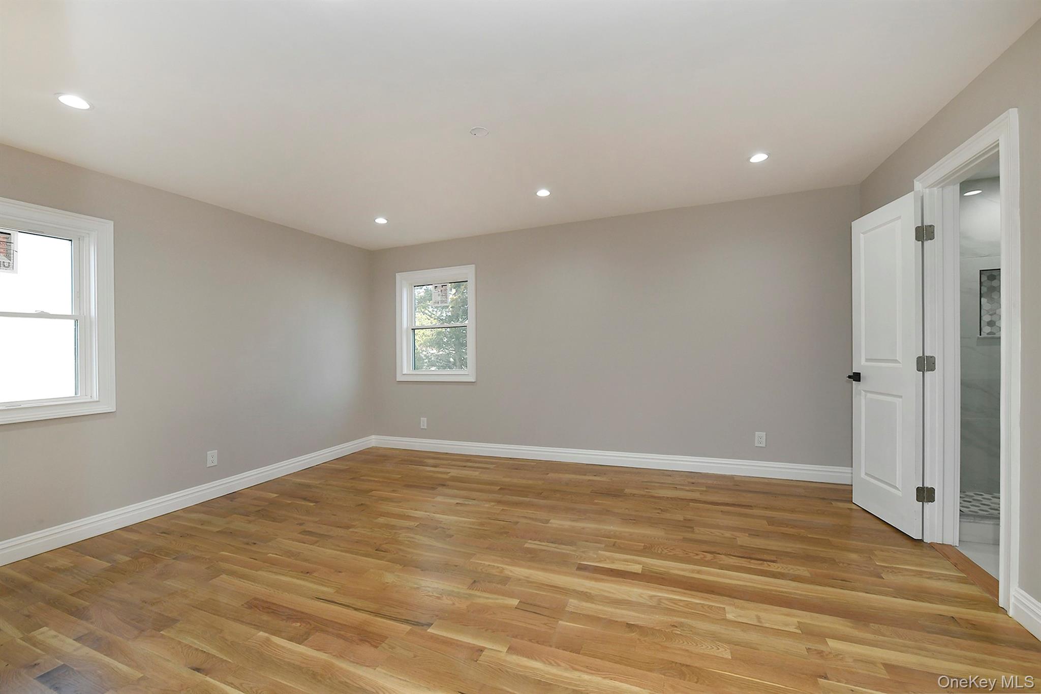 1903 George Court Merrick, NY 11566 - Photo 21 of 39 a view of an empty room with wooden floor and a window