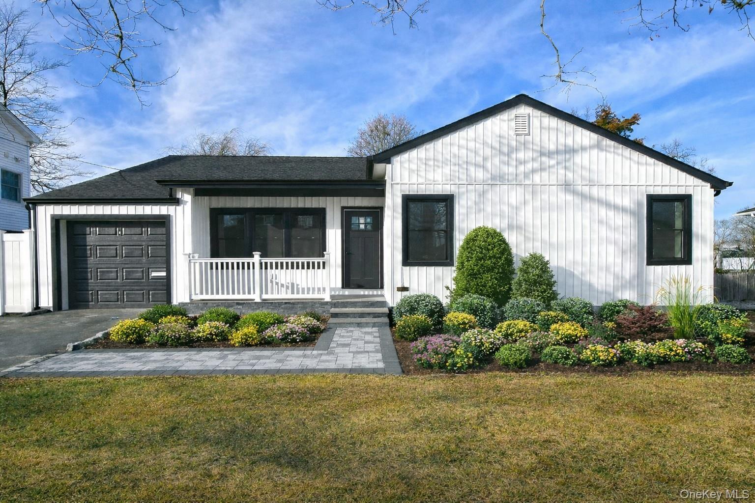1903 George Court Merrick, NY 11566 - Photo 3 of 39 a front view of a house with a yard