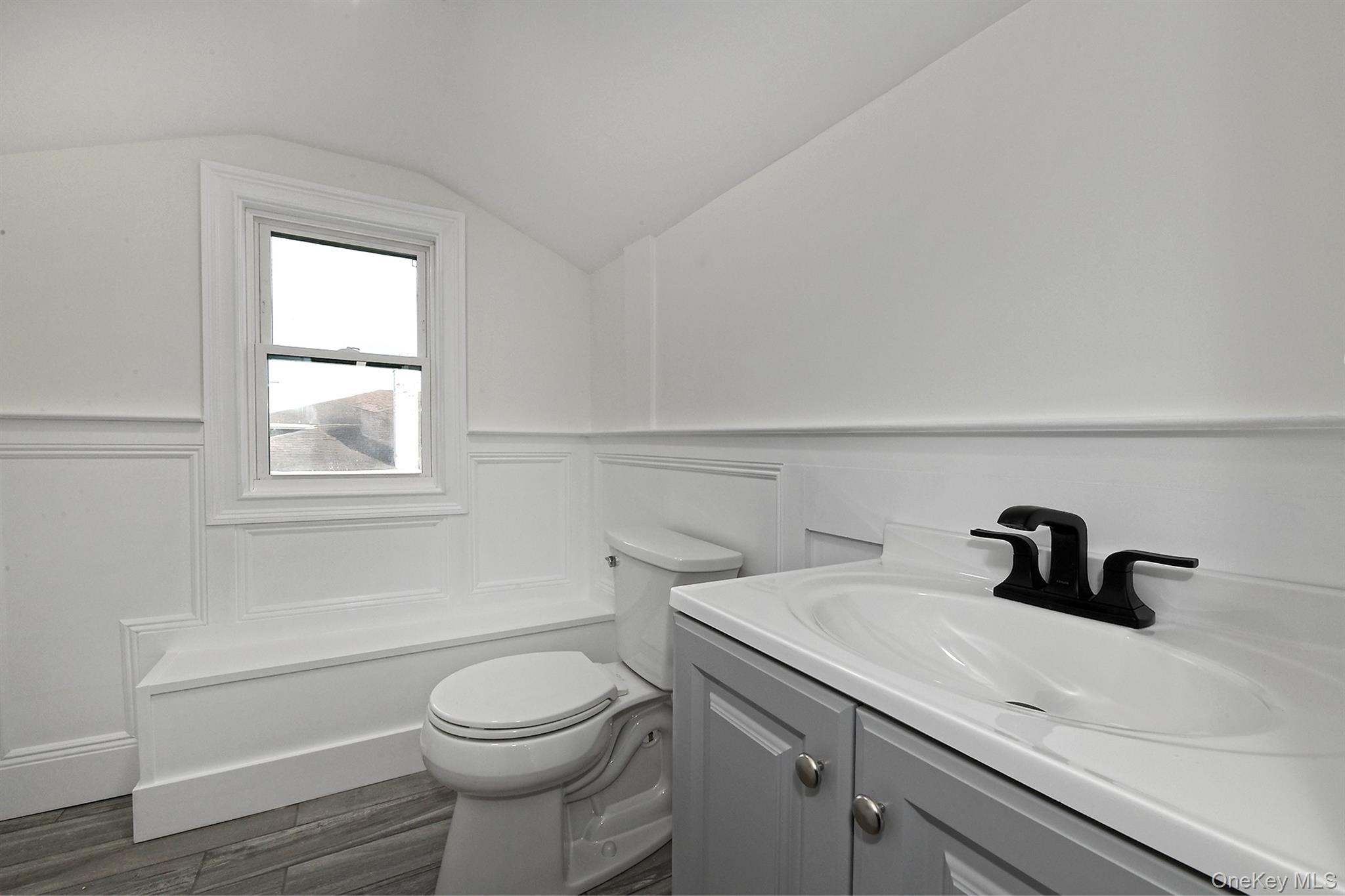 1903 George Court Merrick, NY 11566 - Photo 32 of 39 a bathroom with a sink a toilet and window