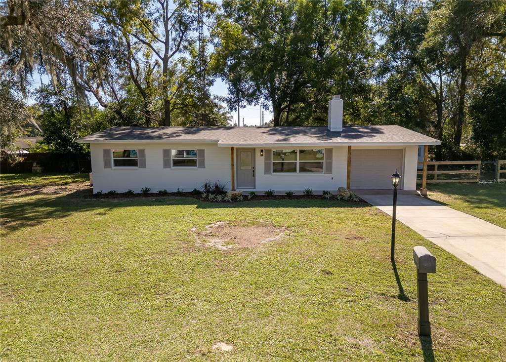 2909 Adams Street West Inverness, FL 34453 - Photo 1 of 1 a front view of house with yard and seating area