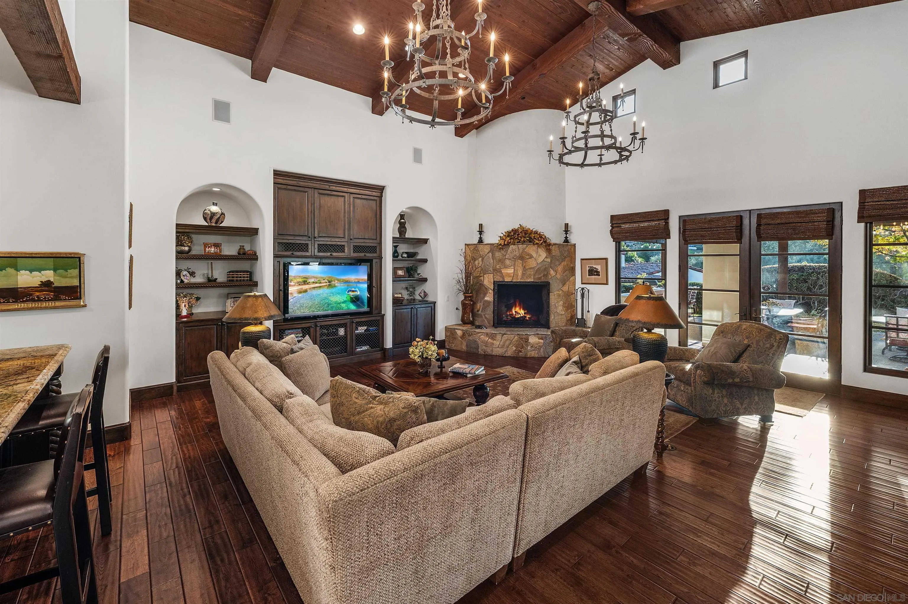 6870 La Valle Plateada Rancho Santa Fe, CA 92067 - Photo 11 of 37 a living room with fireplace furniture and a chandelier