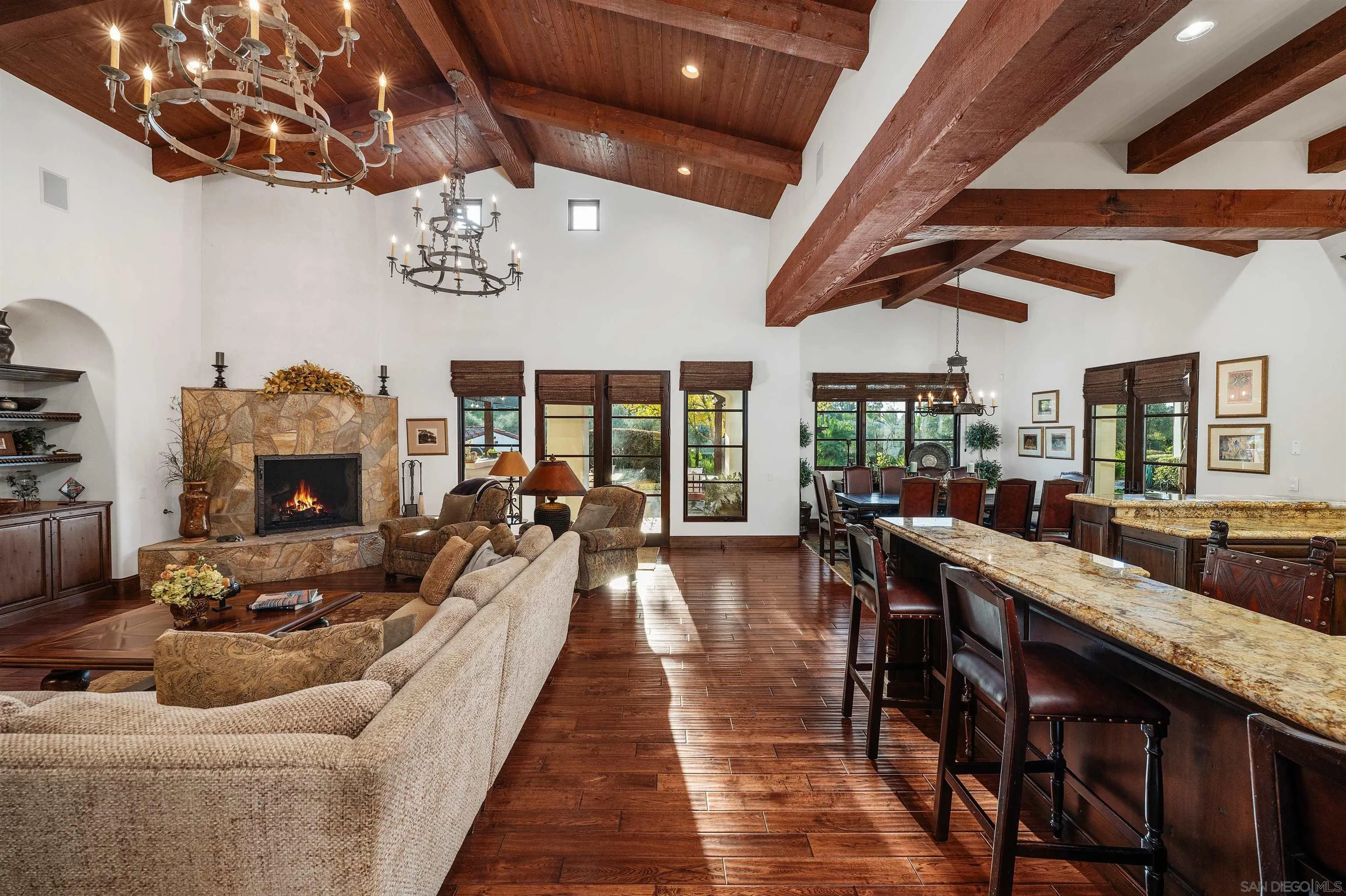 6870 La Valle Plateada Rancho Santa Fe, CA 92067 - Photo 12 of 37 a living room with furniture wooden floor and a fireplace