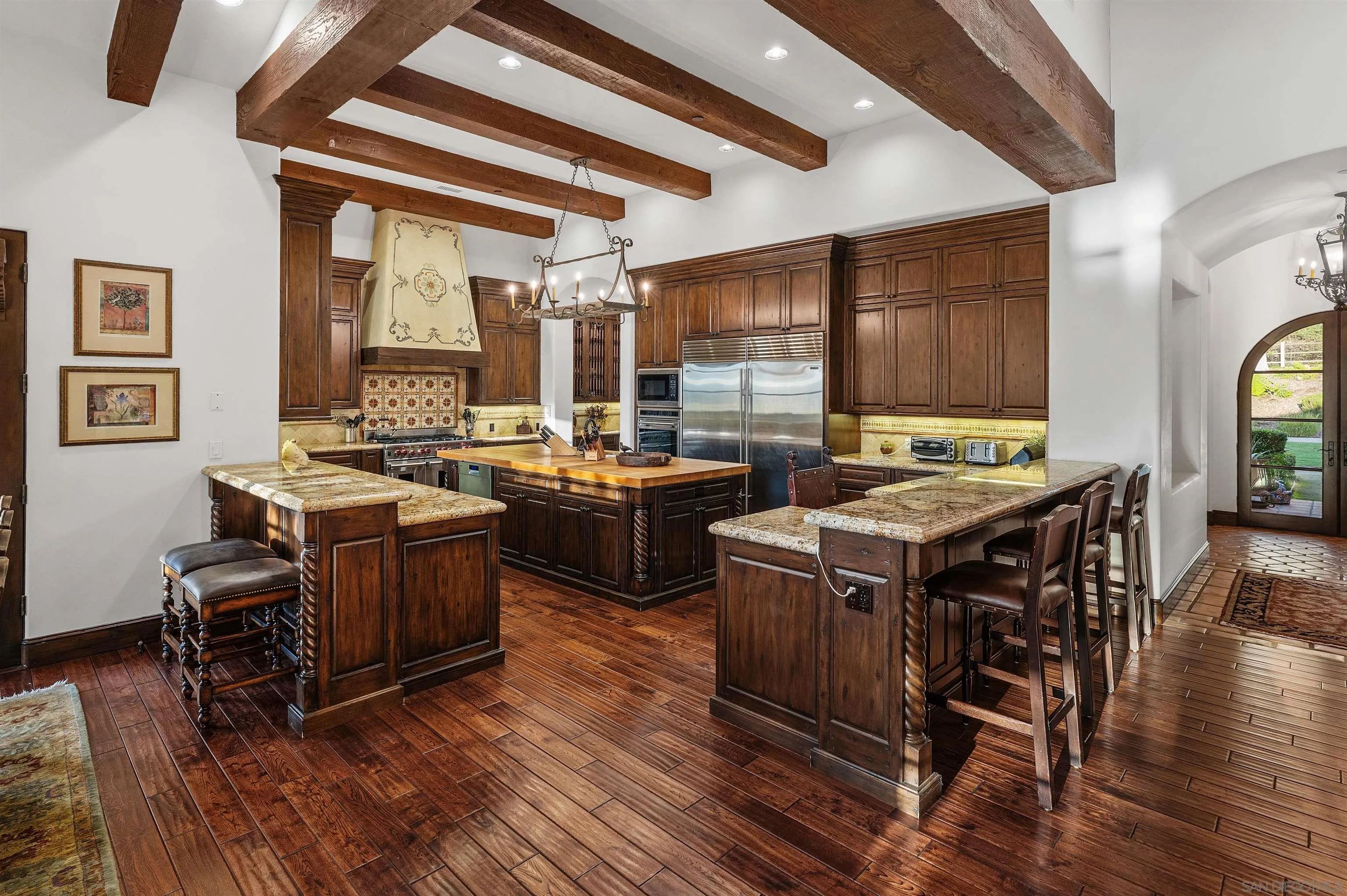 6870 La Valle Plateada Rancho Santa Fe, CA 92067 - Photo 13 of 37 a view of a dining room with furniture window and wooden floor
