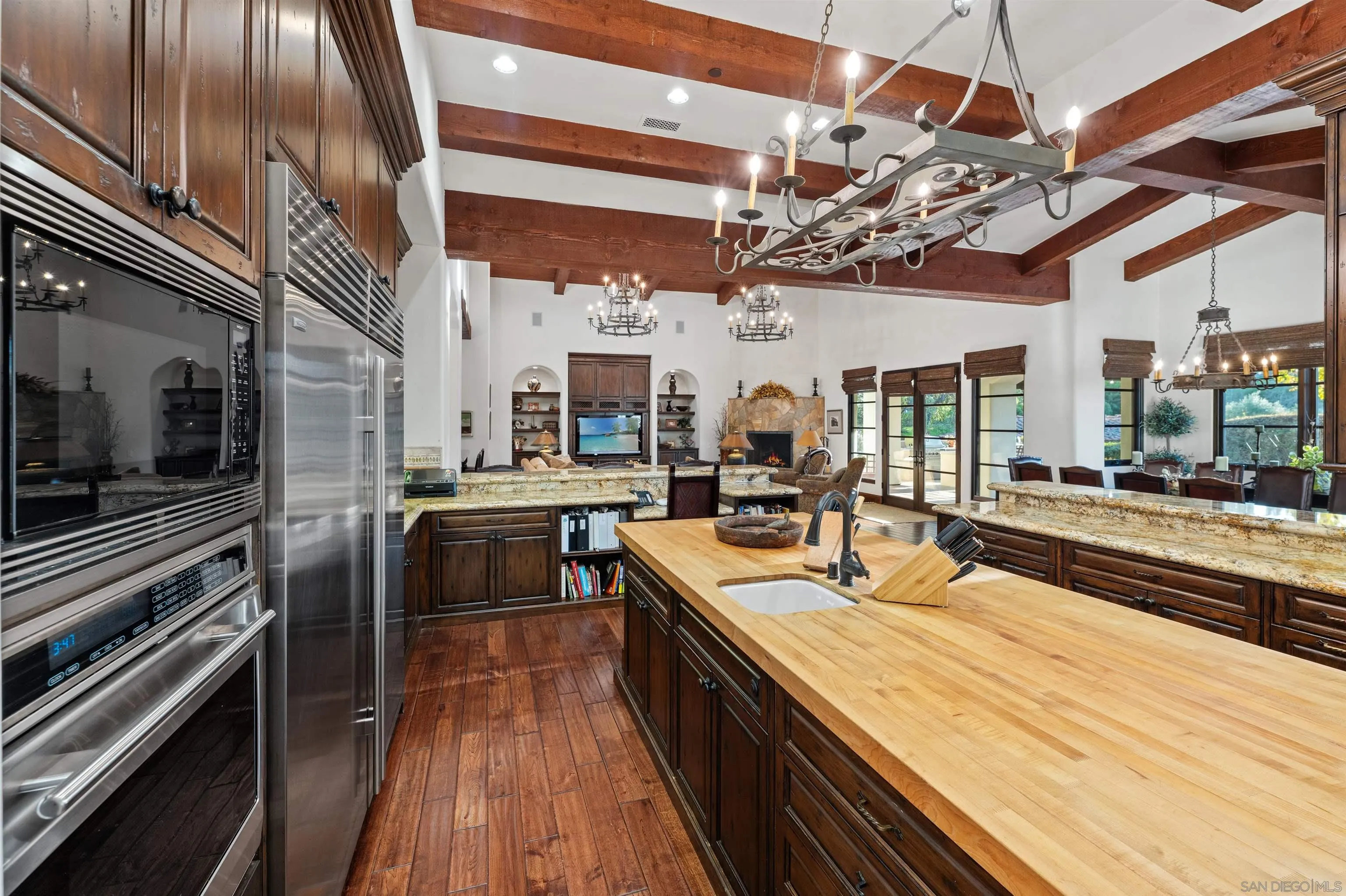 6870 La Valle Plateada Rancho Santa Fe, CA 92067 - Photo 14 of 37 a large kitchen with stainless steel appliances sink stove and cabinets