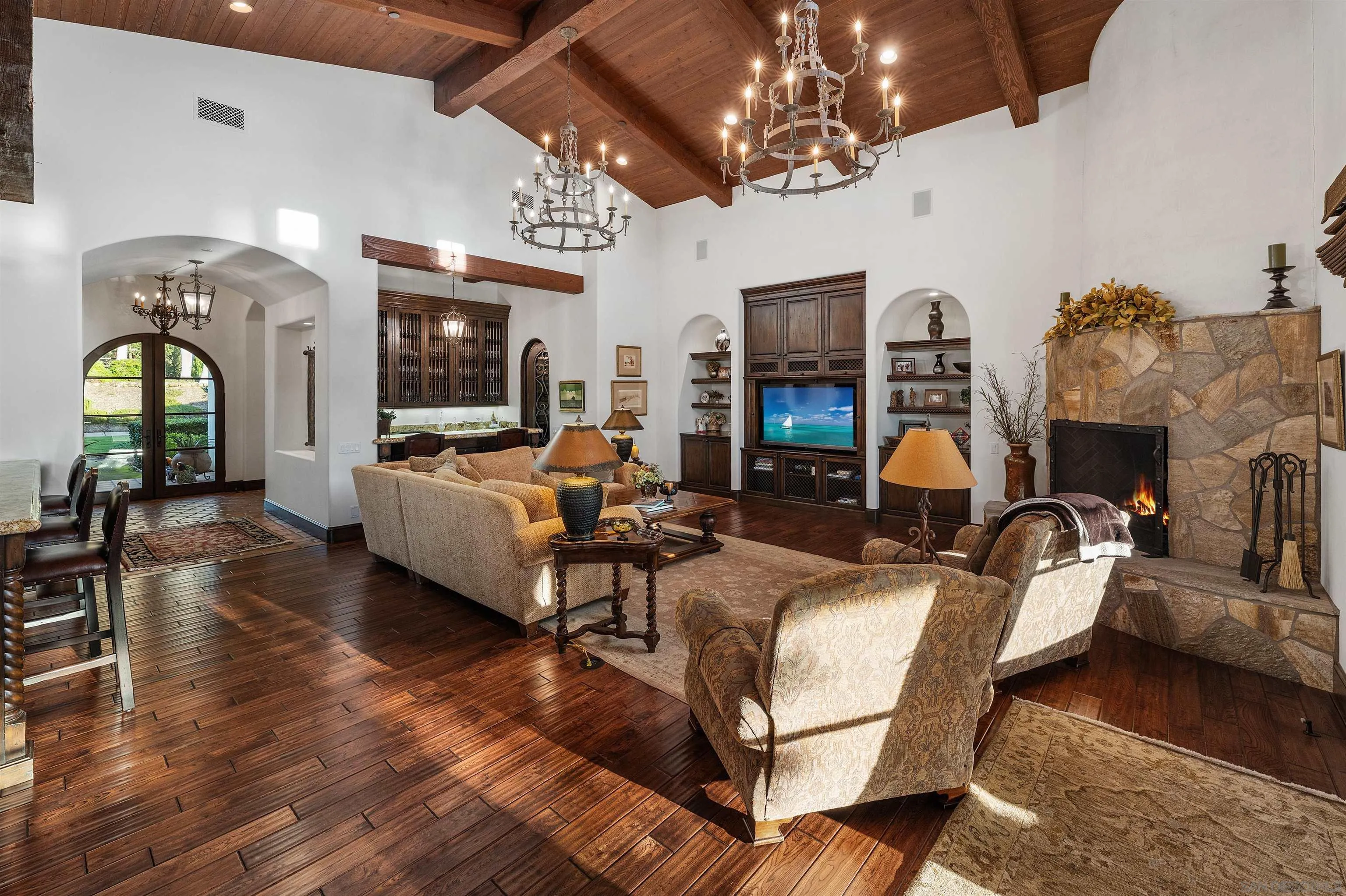 6870 La Valle Plateada Rancho Santa Fe, CA 92067 - Photo 16 of 37 a living room with furniture chandelier and fireplace