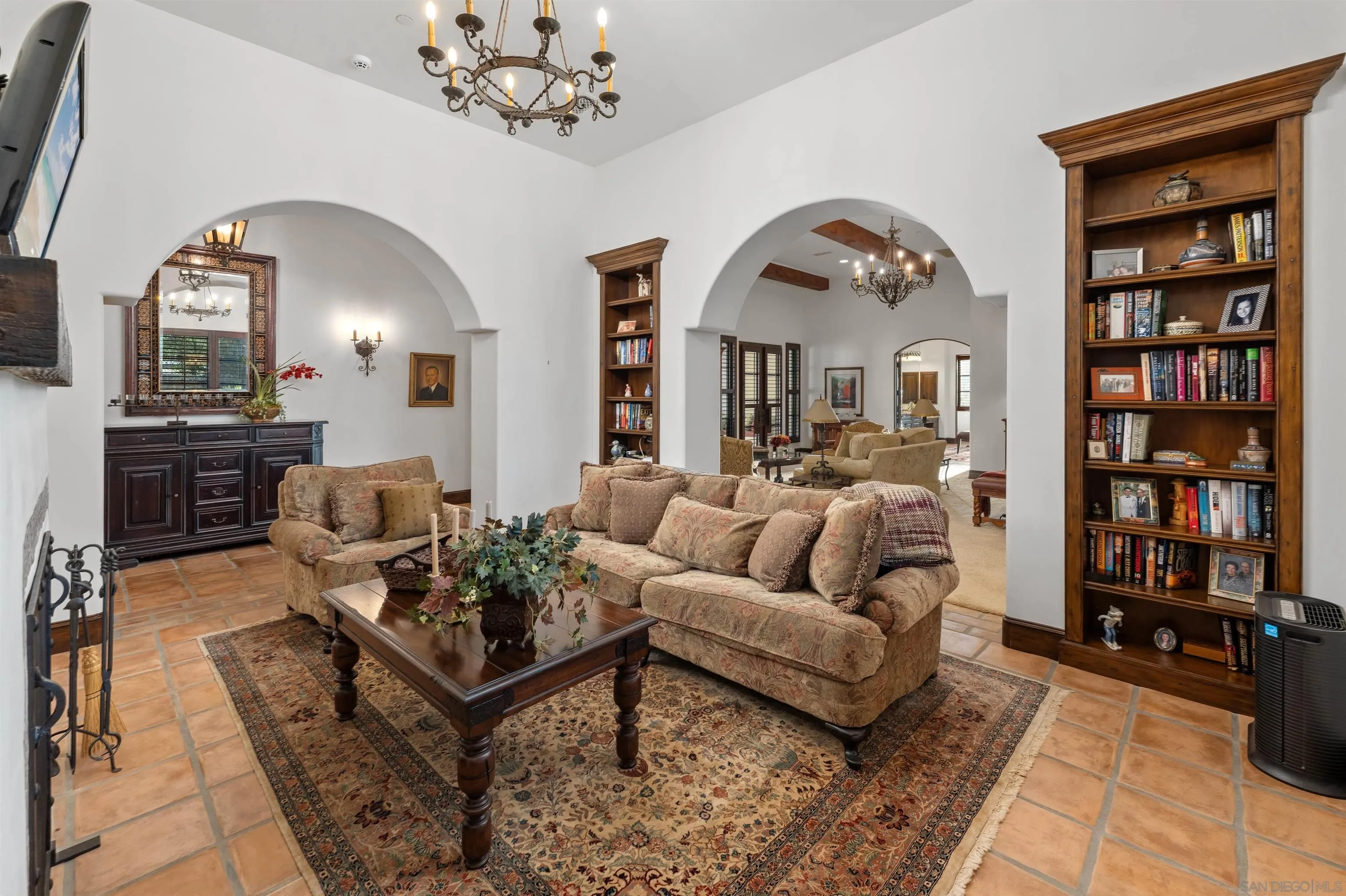 6870 La Valle Plateada Rancho Santa Fe, CA 92067 - Photo 17 of 37 a living room with furniture a chandelier and wooden floor
