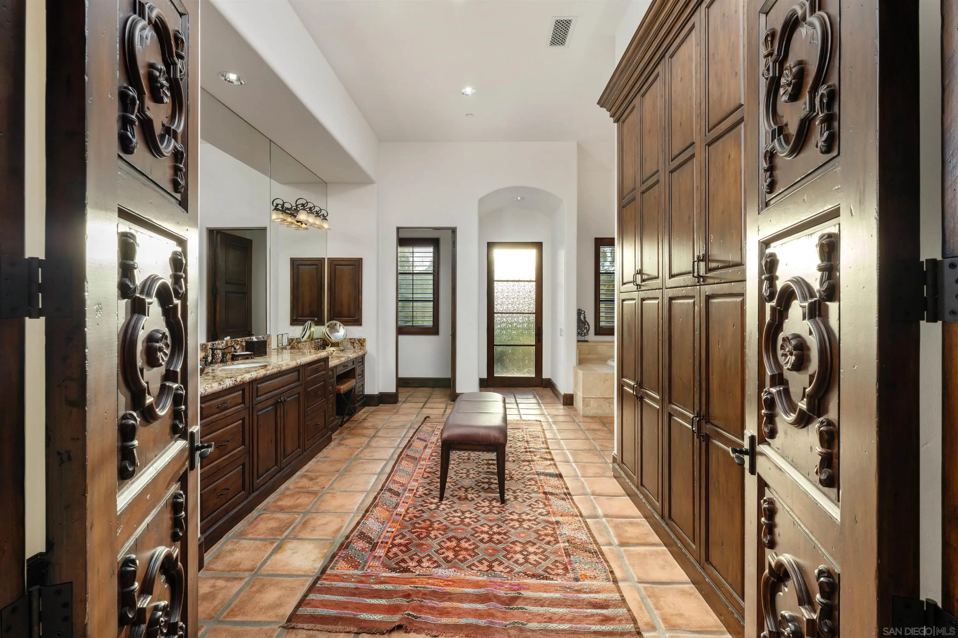 6870 La Valle Plateada Rancho Santa Fe, CA 92067 - Photo 25 of 37 a hallway with many black and white appliances