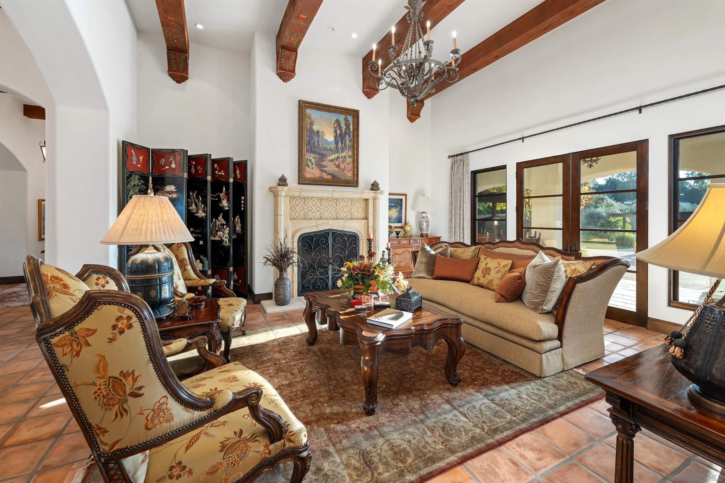 6870 La Valle Plateada Rancho Santa Fe, CA 92067 - Photo 9 of 37 a living room with furniture a fireplace and a chandelier