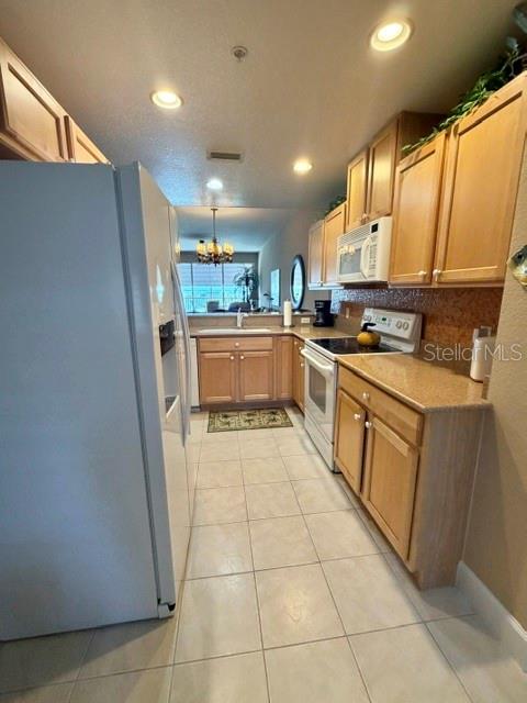 13413 Gasparilla Road, Unit 304 Placida, FL 33946 - Photo 18 of 28 a kitchen with a sink a counter top space cabinets and stainless steel appliances
