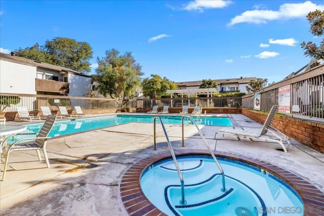 a building outdoor space with patio furniture and potted plants