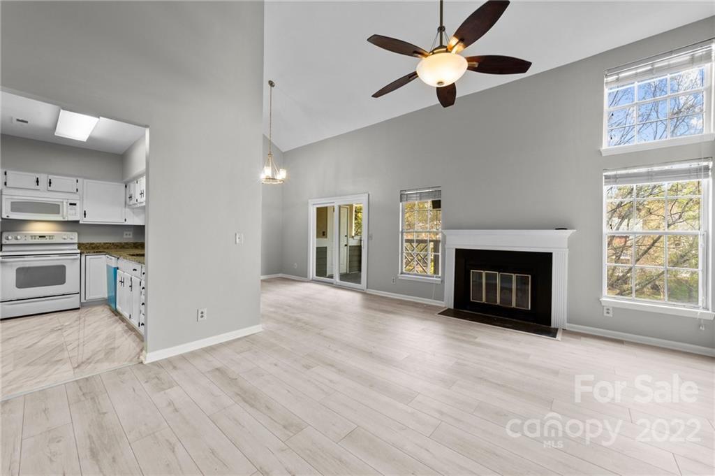 20105 Henderson Road, Unit E Cornelius, NC 28031 - Photo 11 of 23 a view of an empty room with a kitchen and a fireplace