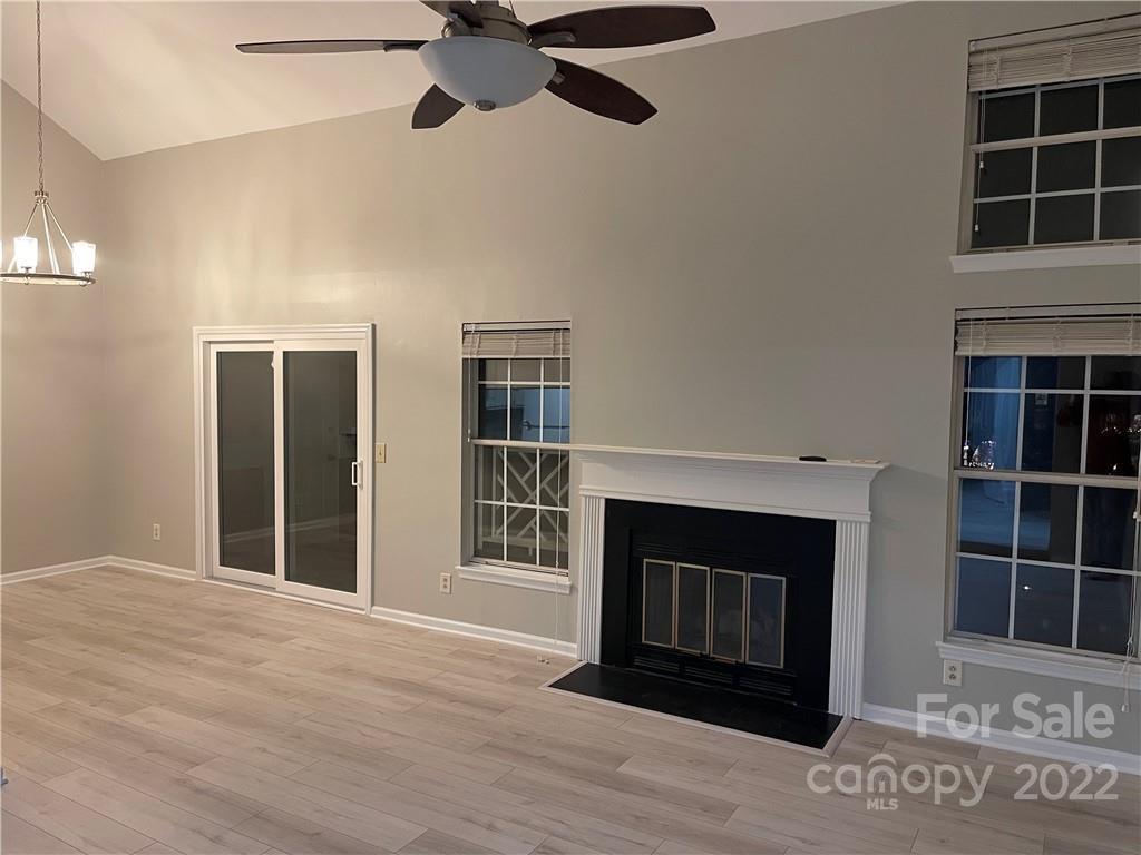20105 Henderson Road, Unit E Cornelius, NC 28031 - Photo 20 of 23 a living room with a fireplace and a window