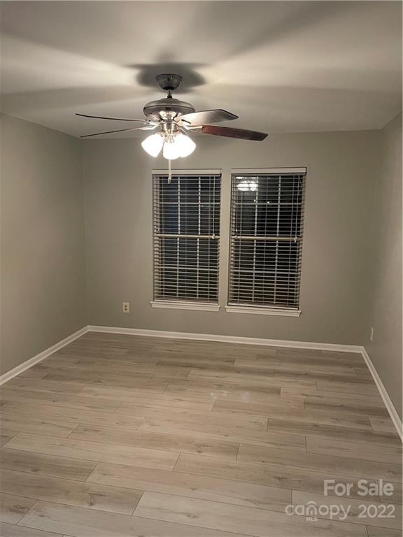 20105 Henderson Road, Unit E Cornelius, NC 28031 - Photo 22 of 23 a view of an empty room with a window and chandelier fan