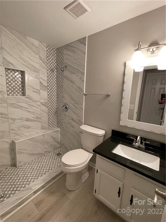 20105 Henderson Road, Unit E Cornelius, NC 28031 - Photo 23 of 23 a bathroom with a sink and a mirror
