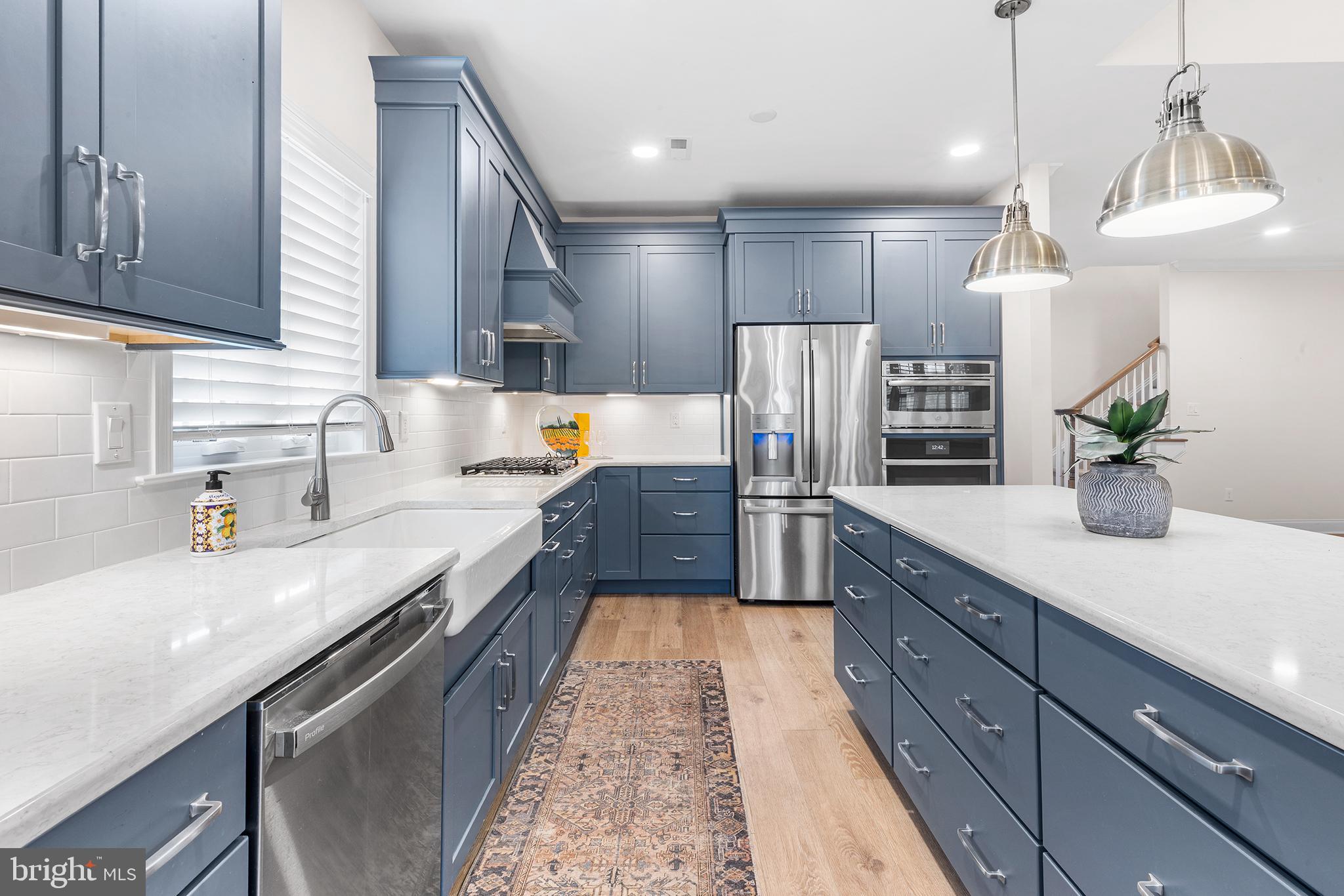 116 American Way Downingtown, PA 19335 - Photo 3 of 41 a large kitchen with stainless steel appliances kitchen island granite countertop a sink a counter space cabinets and a potted plant
