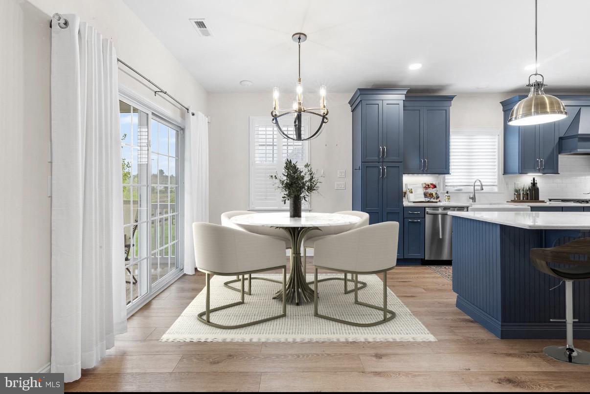 116 American Way Downingtown, PA 19335 - Photo 4 of 41 a dining room with wooden floor a chandelier a glass table and chairs