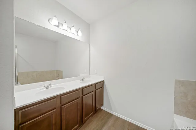 a bathroom with a sink a large mirror and a vanity
