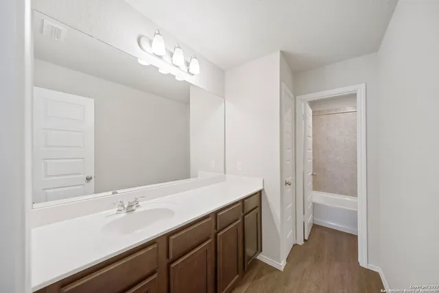a bathroom with a sink a vanity and a mirror