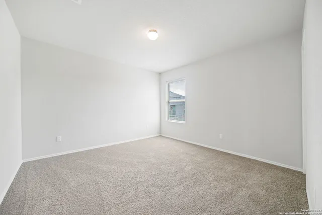 a view of an empty room and a window