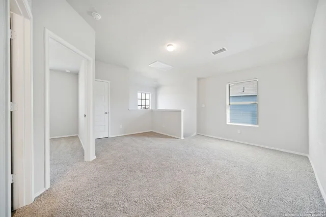 an empty room with windows and closet