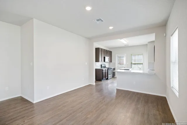 a view of a hallway with a kitchen